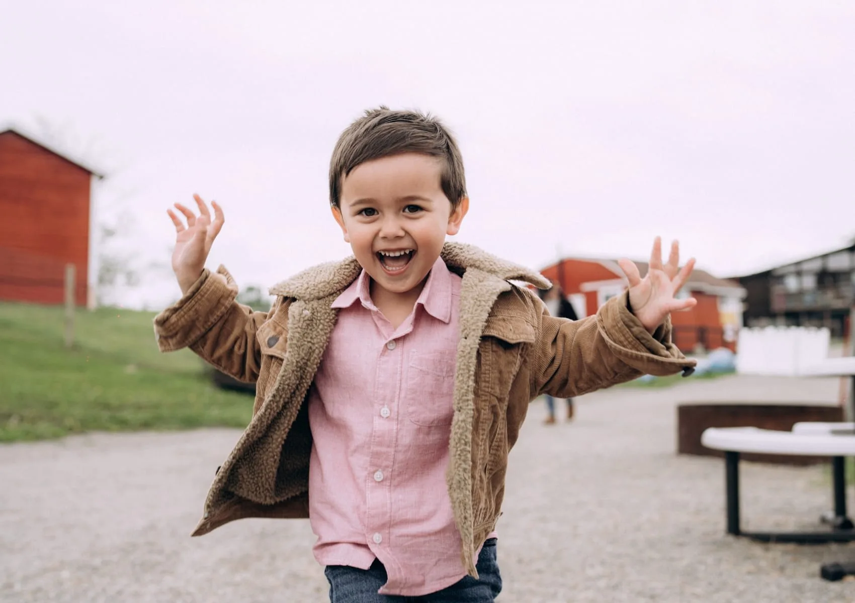 A child jumping with excitement during a farm visit.