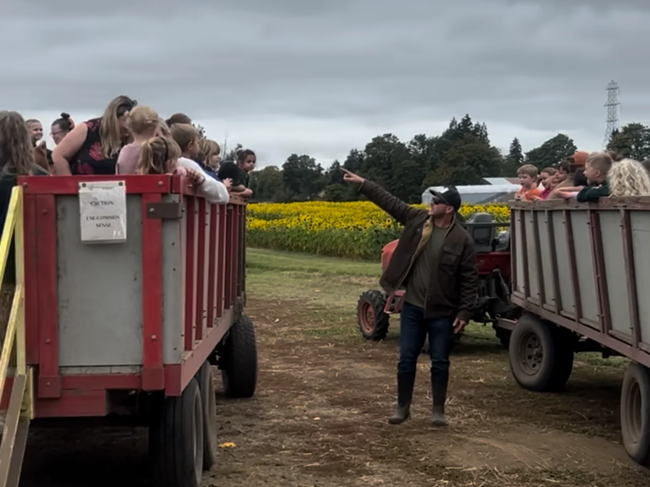 Families ride in two hayride wagons at Johnson Vegetable Farms.